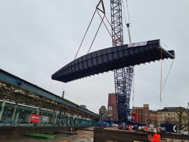 South Wales Argus: A section of the new footbridge is lifted over Newport railway station. Picture: Pro Steel Engineering
