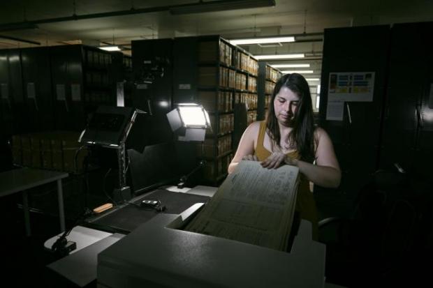South Wales Argus: Photo via PA shows Findmypast technician Laura Gowing scans individual pages of the 30,000 volumes of the 1921 Census at the Office for National Statistics (ONS) near Southampton.