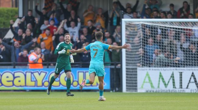 JOY: County fans celebrate in the background after Robbie Willmott's goal at Exeter