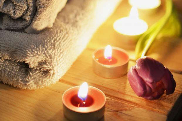 South Wales Argus: A pile of towels, candles and a tulip. Credit: Canva