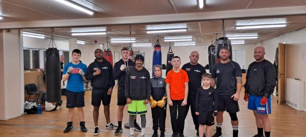 South Wales Argus: Mark James (third from right) with some of the youngsters at his boxing club.