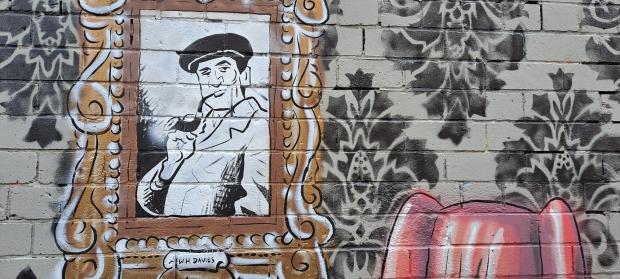 South Wales Argus: Pill born poet W.H. Davies is featured as part of the mural. 