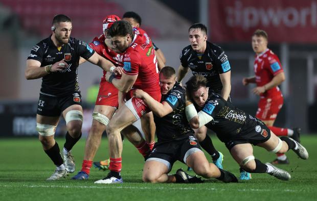 South Wales Argus: Taylor Davies puts in a tackle for the Dragons against the Scarlets
