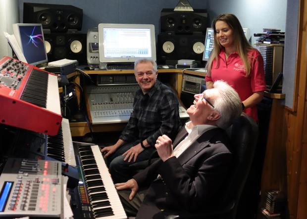 South Wales Argus: A celebration: Tania Ansell of St David's Hospice Care with Kelvin Reddicliffe (seated) and Carl Simmonds, put the final touches to the CD at Pinewood Audio studios, Pontypool. Picture: DBPR