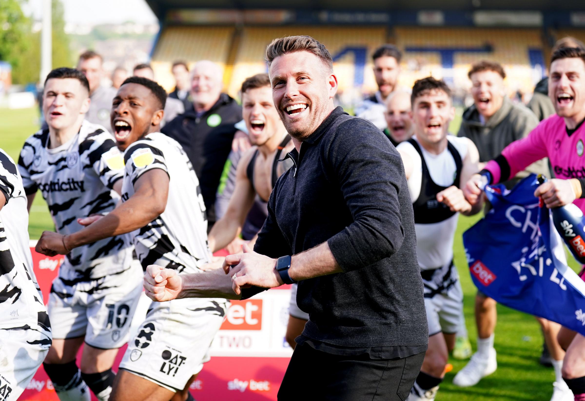 Forest Green Rovers manager Rob Edwards (centre) celebrating after his side won the league after the final whistle of the Sky Bet League Two match at the One Call Stadium, Mansfield. Picture date: Saturday May 7, 2022. PA Photo. See PA story SOCCER