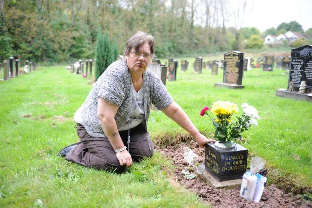 South Wales Argus: Cheryl Downes at her son Leon's grave in Panteg Cemetery in 2014.