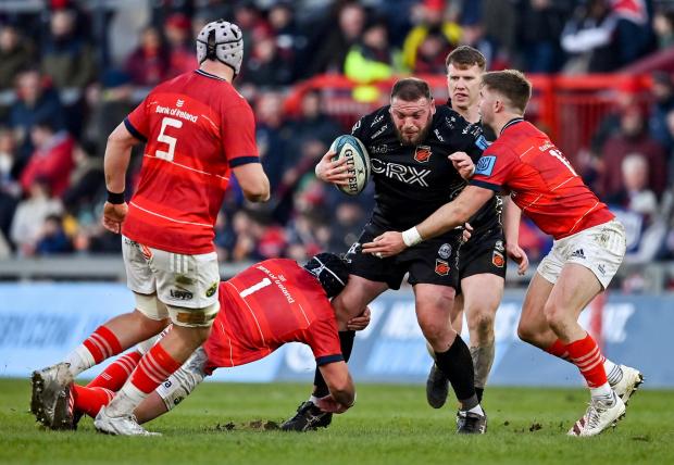 South Wales Argus: Greg Bateman is tackled by Josh Wycherley and Jack Crowley as Dragons faced Munster in the United Rugby Championship. Picture: Huw Evans Picture Agency.