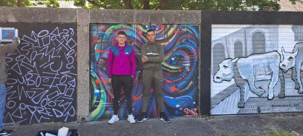South Wales Argus: Two passers-by pose with the artwork. 