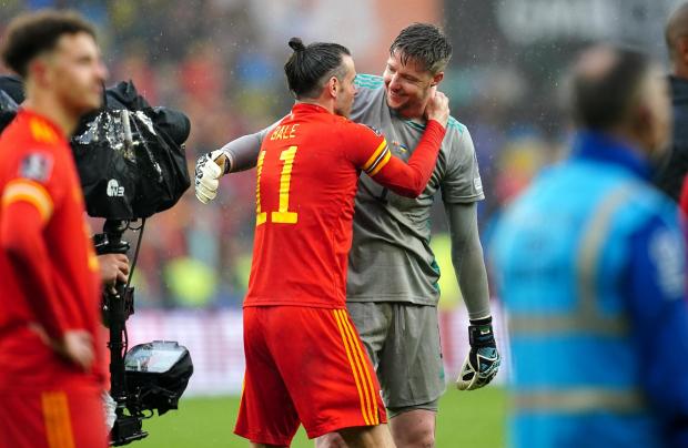 South Wales Argus: Gareth Bale and Wayne Hennessey embrace after the final whistle. Picture: PA Wire