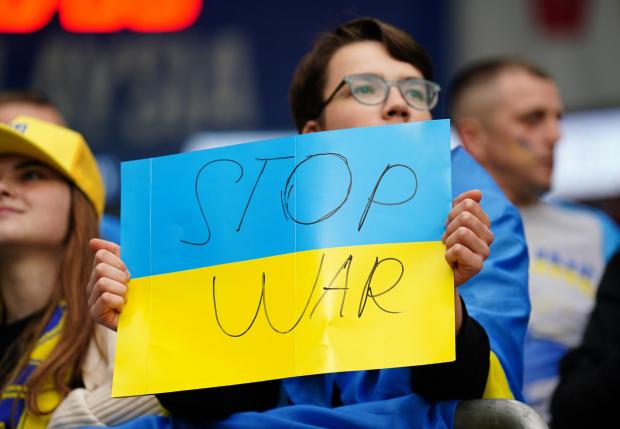 South Wales Argus: A Ukraine fan displays an anti-war message during his nation's match against Wales. Picture: PA Wire