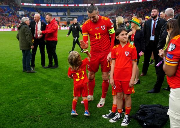 South Wales Argus: Gareth Bale with his children after Wales sealed a place at the World Cup. Picture: PA Wire