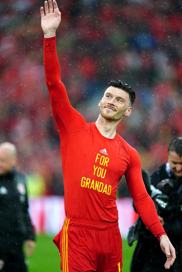South Wales Argus: Kieffer Moore displays a personal message after the match. Picture: PA Wire