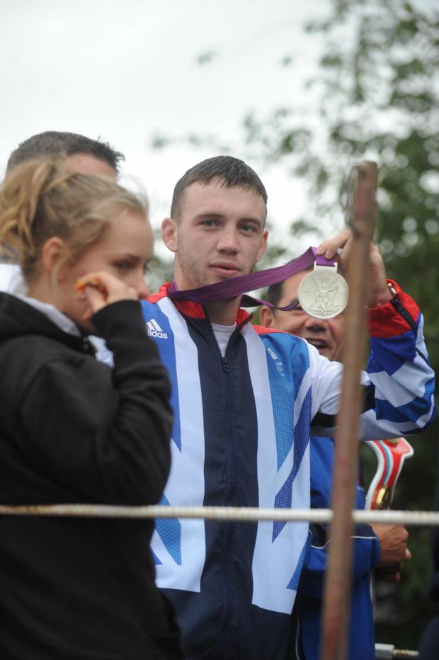 South Wales Argus: Argus-Mark    Reporter-Deans  27-08-12
Pill Carnival
Fred Evans shows off his Olympic silver medal aboard the St Josephs ABC float