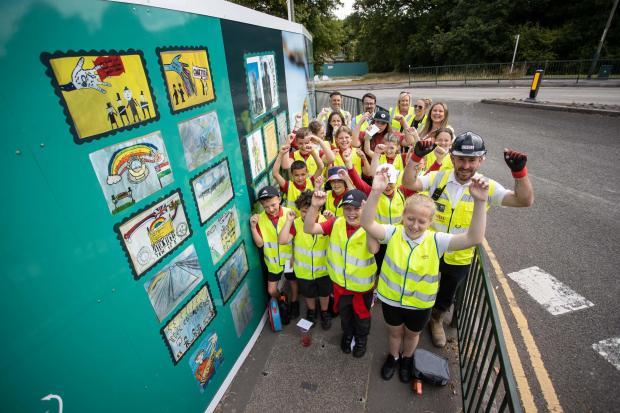 South Wales Argus: Pontllanfraith Primary School children with Lovell and Pobl, at Chartist Garden Village