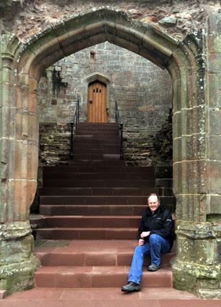 Alan Cornish in front of the refurbished hokey cokey staircase at Raglan Castle