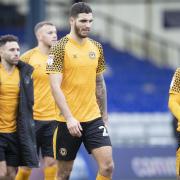 DEJECTED: Defender Ryan Inniss leads the Newport County players off the pitch after Saturday's 5-0 defeat at Oldham Athletic.