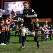 LEGEND: Lewis Evans leads out the Dragons on his 200th appearance