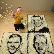 Nathan Wyburn with his popcorn portraits of (clockwise) Gareth Bale, Harry Kane and Andrew Robertson to celebrate teh Euros and Showcase Cinemas free screeningns of the home nations games.
