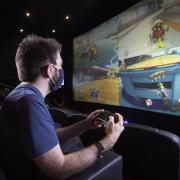 Gaming influencer Rhys Farrant, known online as Gameasertm, plays Xbox on the big screen at Cineworld Leicester Square in London, as the cinema announces private screen hire for gaming fans at 100 different venues across the UK. Credit: PA