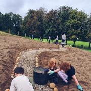 Children getting to work on the Morgan Jones Park Tiny Forest
