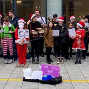 Charlotte Church busks on Queen Street in Cardiff with children from the Awen Project.