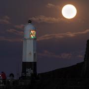 The May full moon, known as the super flower blood moon, rising over the lighthouse at Porthcawl. Photo: Chris Fairweather/Huw Evans Agency