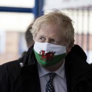 Prime minister Boris Johnson wears a Welsh flag face covering during a visit to Wales in May 2021. Picture: Huw Evans Picture Agency