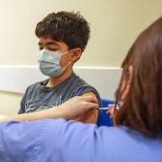 Photo shows at-risk Xavier Aquilina, aged 11, getting his Covid-19 vaccination at a health centre in England. Photo via PA.