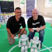 FUTURISTIC FOOTBALLERS: John Hartson, left and Malcom Allen with two of the robot players