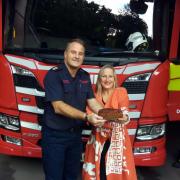 Watch Manager Marty Ellacott  ofDuffryn Fire Station about to tuck in to one of Sharanne Basham-Pyke’s sticky prune cakes.