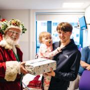 Father Christmas visited hospitals across south Wales to hand deliver presents to children.