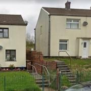 Funding has been approved to replace 'failed' insulation at homes in Caerphilly, through work won't be completed for at least two years.