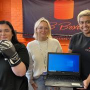L-R: Amy Shea and Kelsie Cantelo from NCH present a laptop to Shereen Williams of KB Boxing