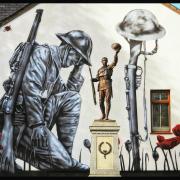 Stunning: Abertillery Cenotaph with a mural behind it. Picture: Leanne Preece