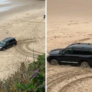 The car stuck in the soft sand on Castle Beach, Tenby