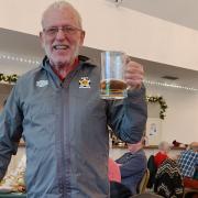 Cheers, Dave Mynott has been honoured for volunteering with the dementia support group he runs and is pictured with an engraved beer mug and top he was surprised with by members at their recent Christmas lunch.