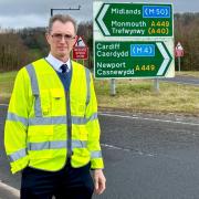 David Davies MP with the mistranslated road sign on the A449 Usk interchange.