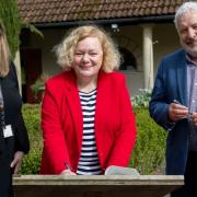 Newport Council leader Jane Mudd (centre) signing the new Caerleon partnership with Nia Williams of Amgueddfa Cymru and Gwilym Hughes of Cadw. Credit: NCC