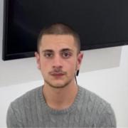 A 21-year-old man is wanted by police for absconding custody