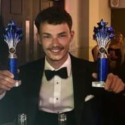Manager Cameron Jones with the pub's two awards of the night