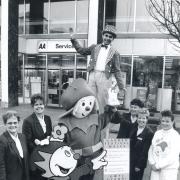 Staff from the AA Service shop with Gryff and man on stilts Maxey and Lisa Watkins promoting the festival in 1992
