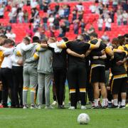 TOGETHER: Newport County players and staff in a huddle at Wembley after losing the League Two play-off final to Tranmere Rovers in May