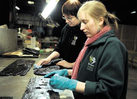 CLEANING: Marie Jordan, left, and Morwenna Perrott working on panels from Newport's medieval ship