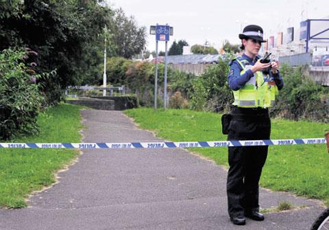 SCENE: A PCSO guards the place where a man’s body was found in Cwmbran