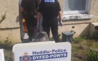 Police at an address in Garnant where £100,000 worth of cannabis was found