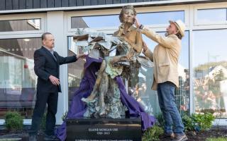 Elaine Morgan's sons Gareth and Morien unveil the statue of their mother.