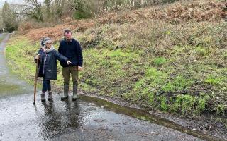 Independent councillor for Ynysddu Jan Jones and amateur chemical pollution investigator Revd Paul Cawthorne look at water flowing from the Ty Llwyd Quarry in Ynysddu, near Caerphilly.