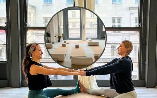 Marian Meek-Jones (left) & Natalie Meek-Jones (right) in couples yoga