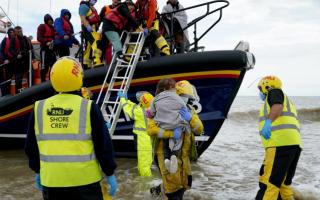 The RNLI assisting asylum seekers who've crossed the English channel to come to Britain. A government scheme requires all local authorities to care for some children who arrive without an adult.