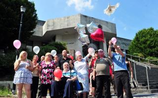 TEARS: Family members look on at the end of the trial as the balloons and doves are released
